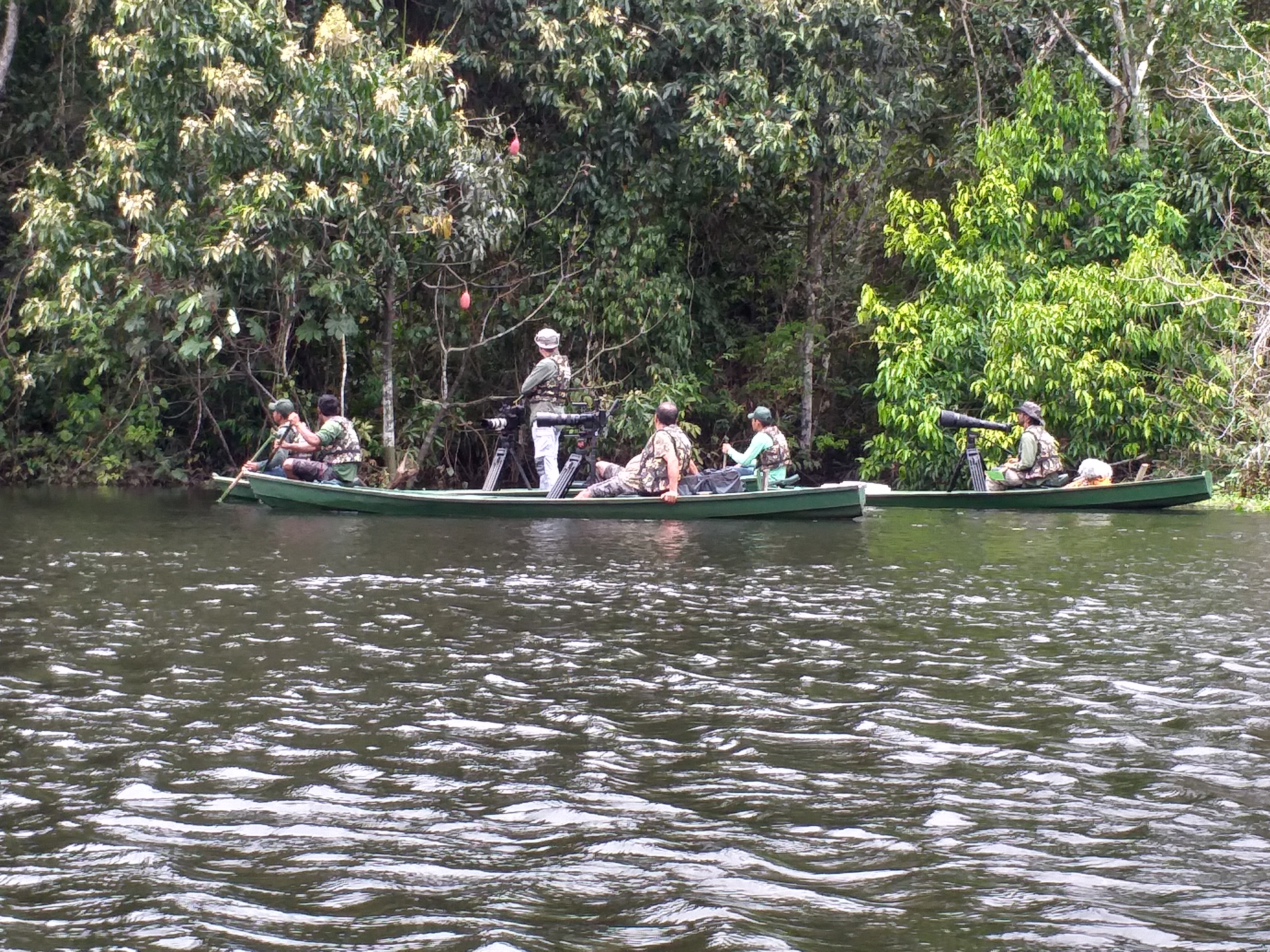 Guests laughing together on a river canoe excursion