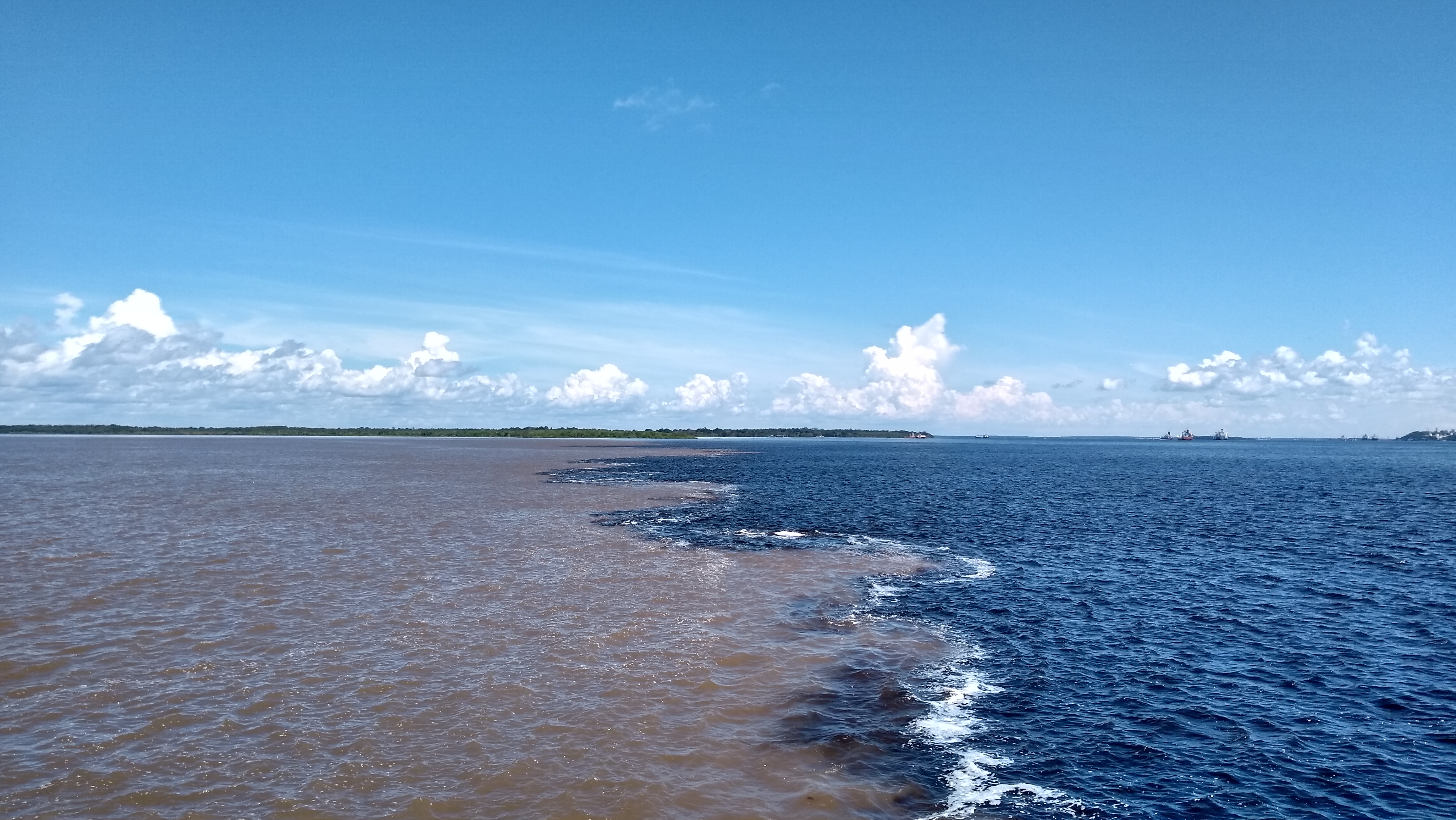 The Meeting of the Waters — dark Rio Negro meets the pale Solimões river near Manaus, Brazil
