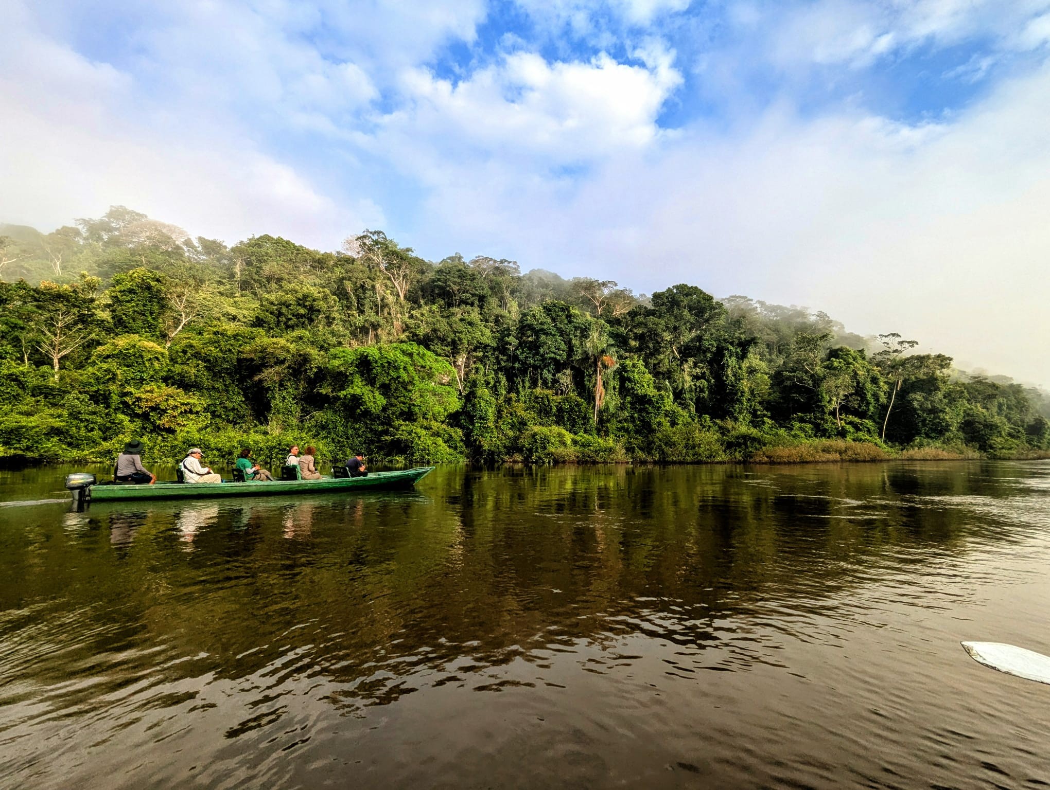 River boat moving through early morning mist on the Amazon